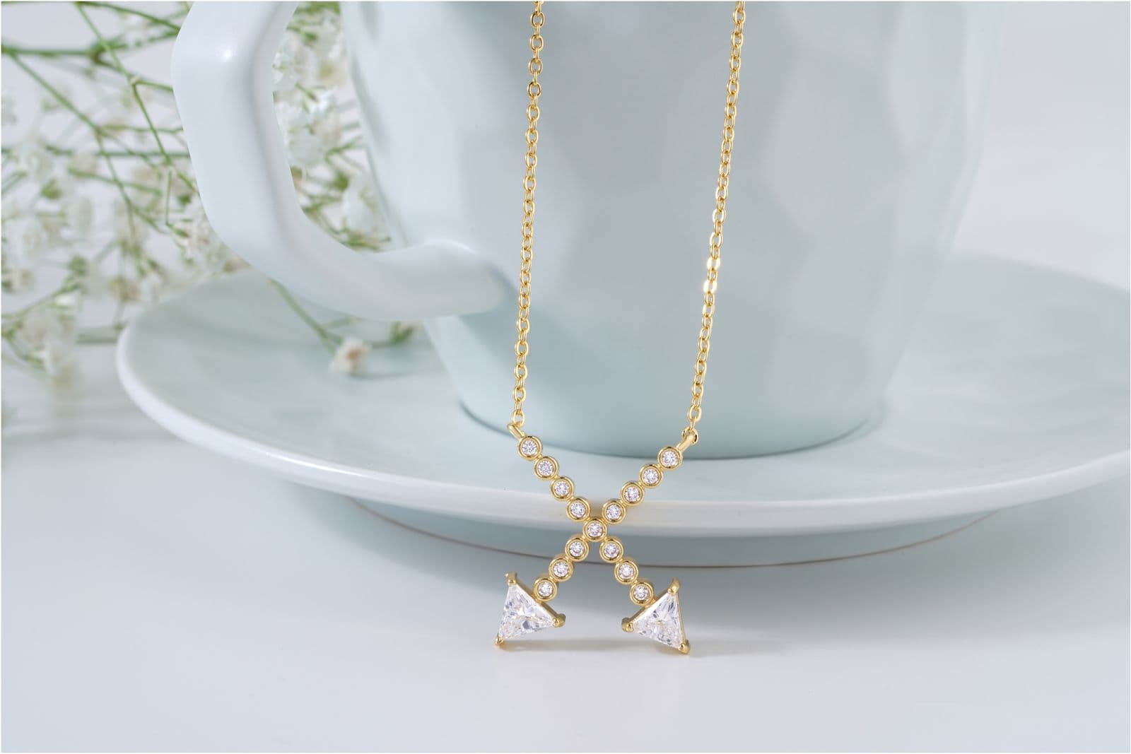 Gold necklace with geometric diamond pendants