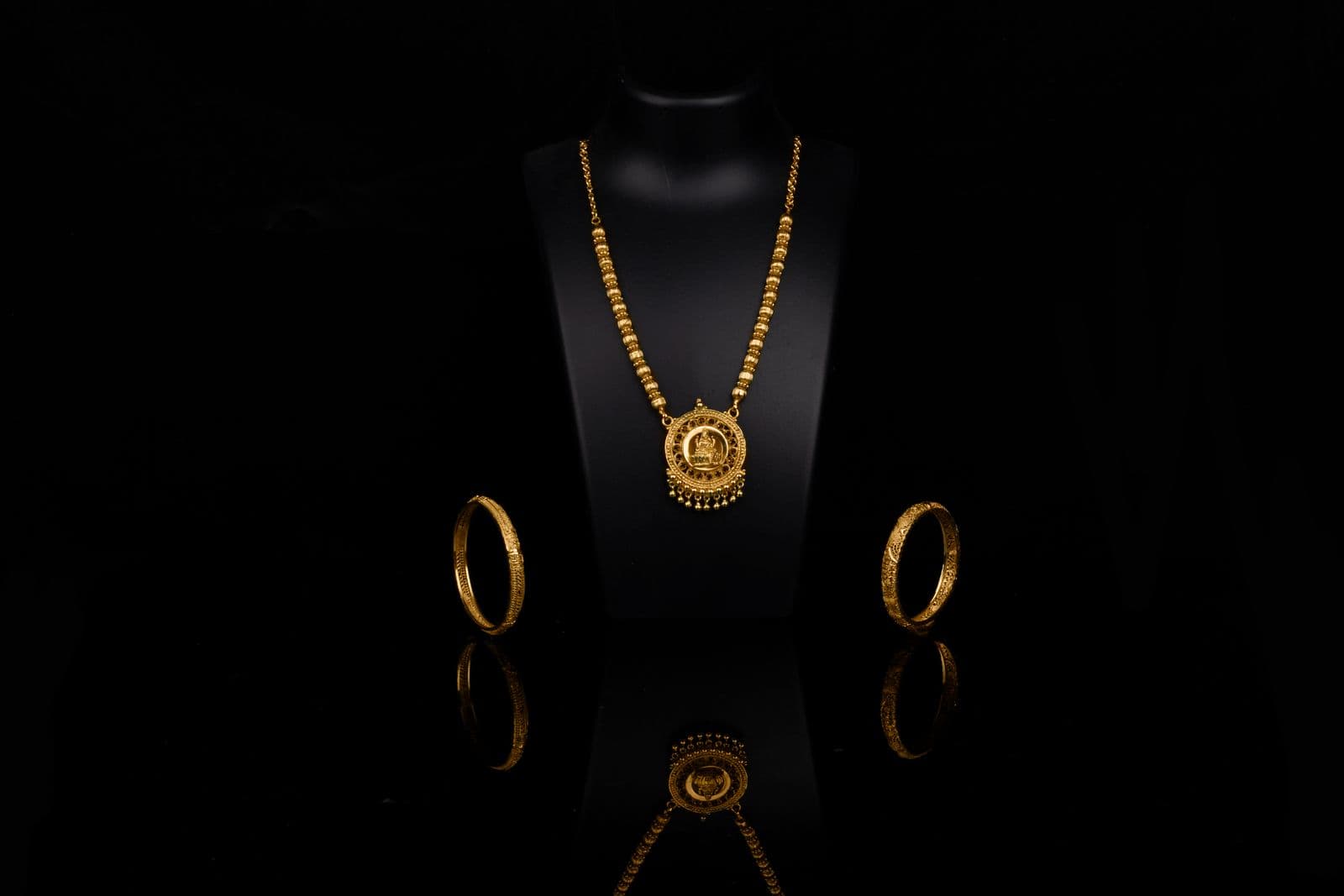 Traditional Indian gold jewelry on a dark display